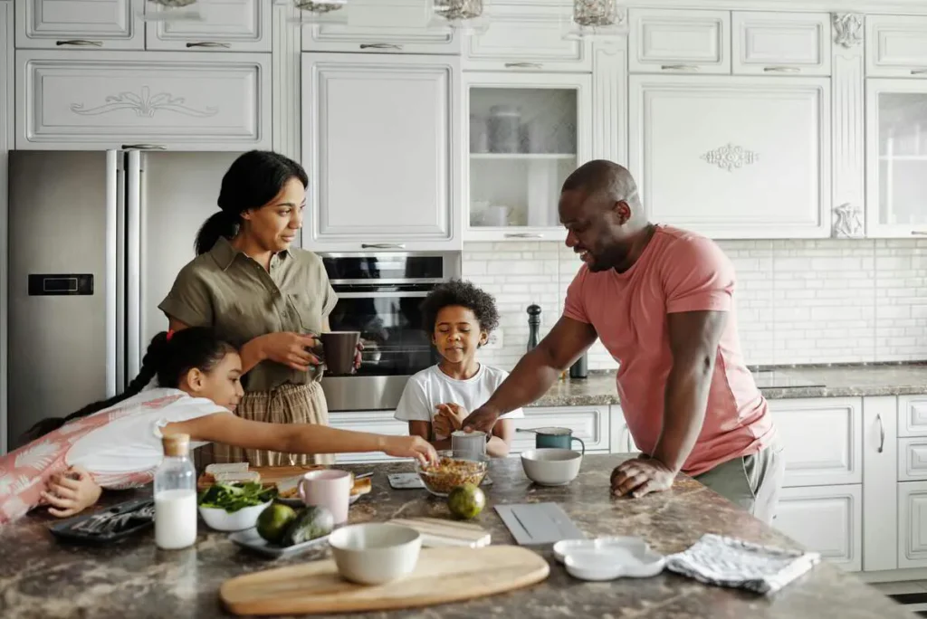 Family preparing a meal together at the kitchen bench