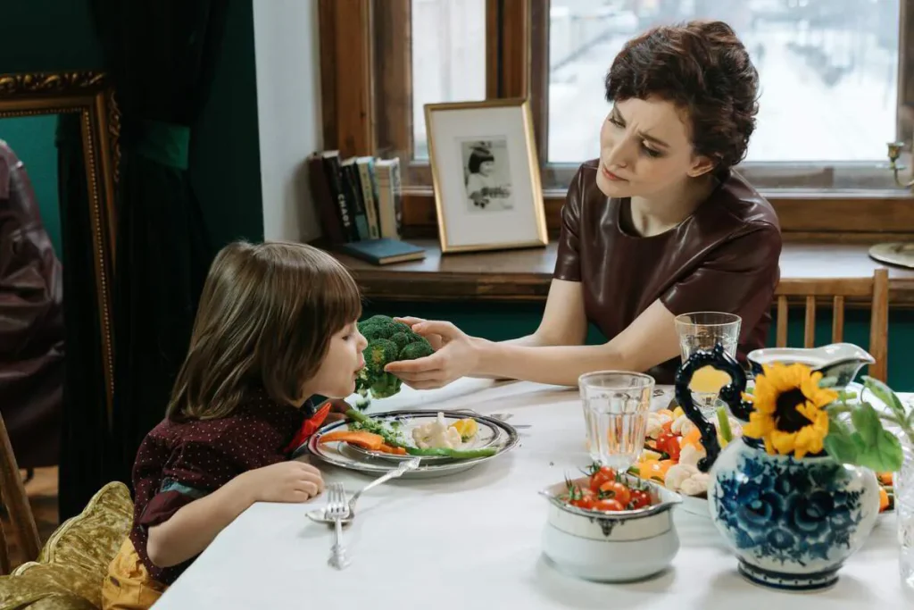 Mother and young daughter sharing a healthy meal at the table