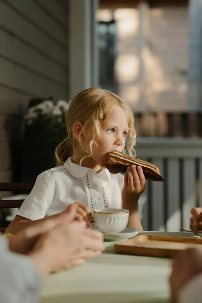 Young girl eating toast at the breakfast table